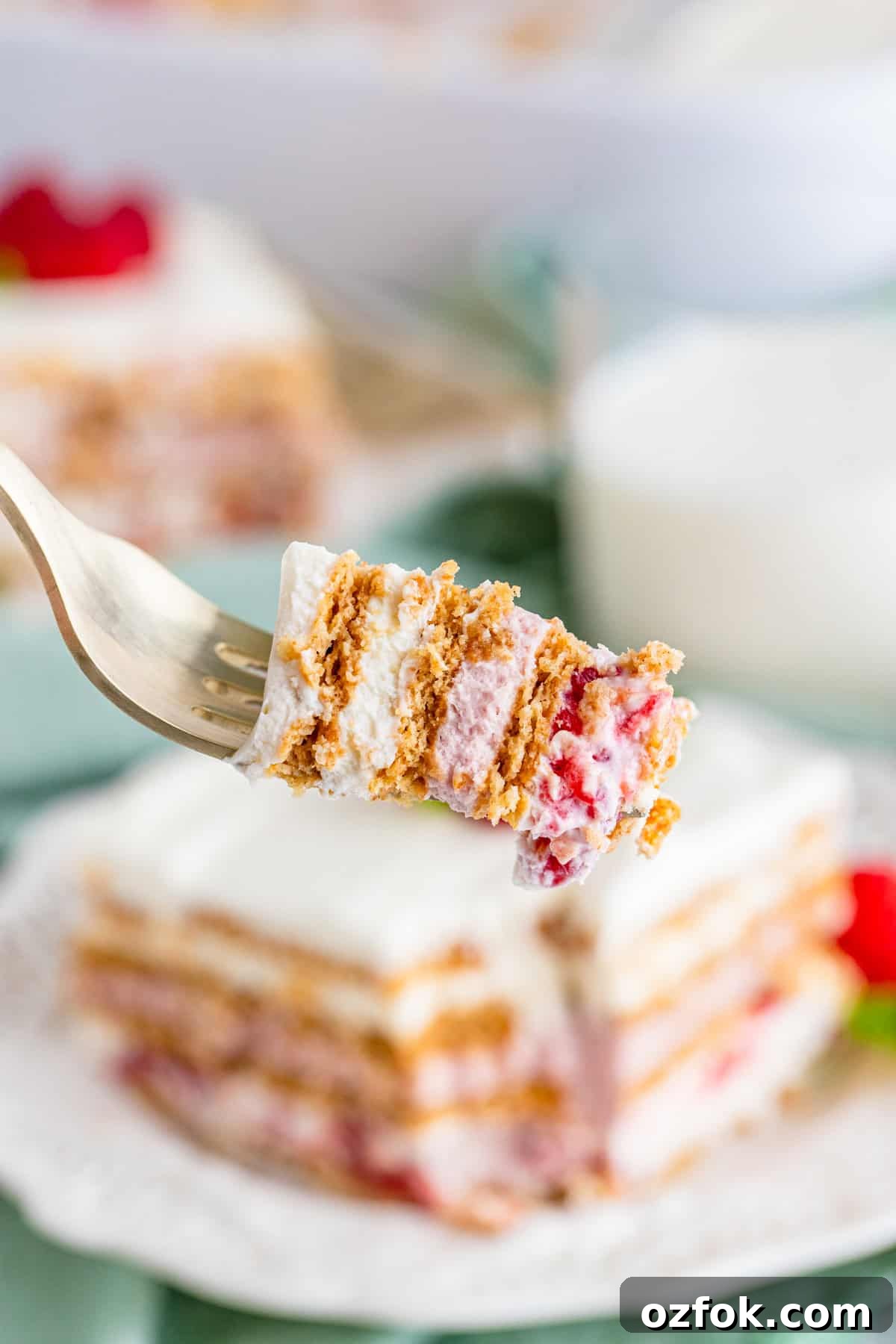 No-Bake Raspberry Icebox Cake Recipe for Summer Parties 16 A fork holding up a layered bite of Raspberry Icebox Cake.