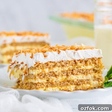 One slice of Coconut Icebox Cake on white plate showing layers.