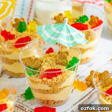 Easy sand pudding cups topped with gummi bears and a cocktail umbrella.