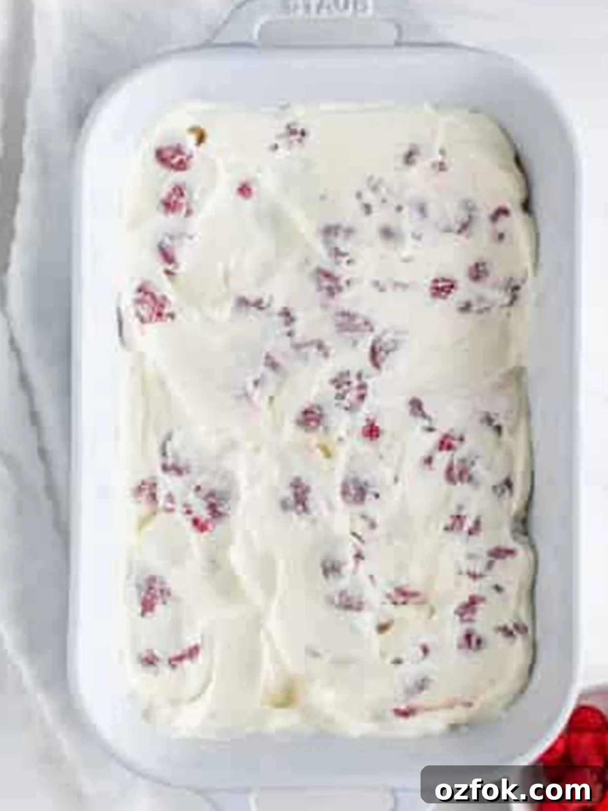 No-Bake Raspberry Icebox Cake Recipe for Summer Parties 9 Fresh raspberry whipped cream layer smoothed to the edges for Raspberry Icebox Cake.