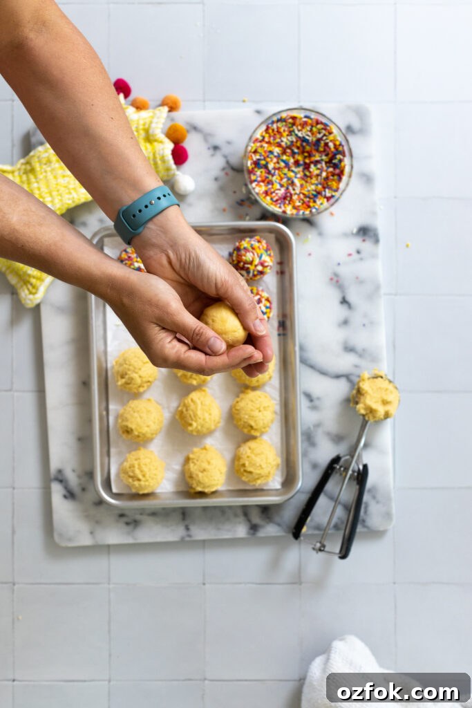 Lemon Rainbow Sprinkle Cookies Recipe — Bright Citrus Sugar Cookies 16 rolling lemon cookie dough into ball