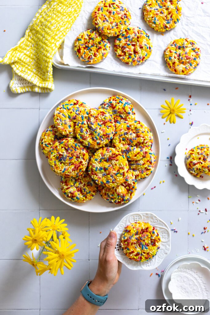 Lemon Rainbow Sprinkle Cookies Recipe — Bright Citrus Sugar Cookies 23 Loading a sprinkle cookie on the plate