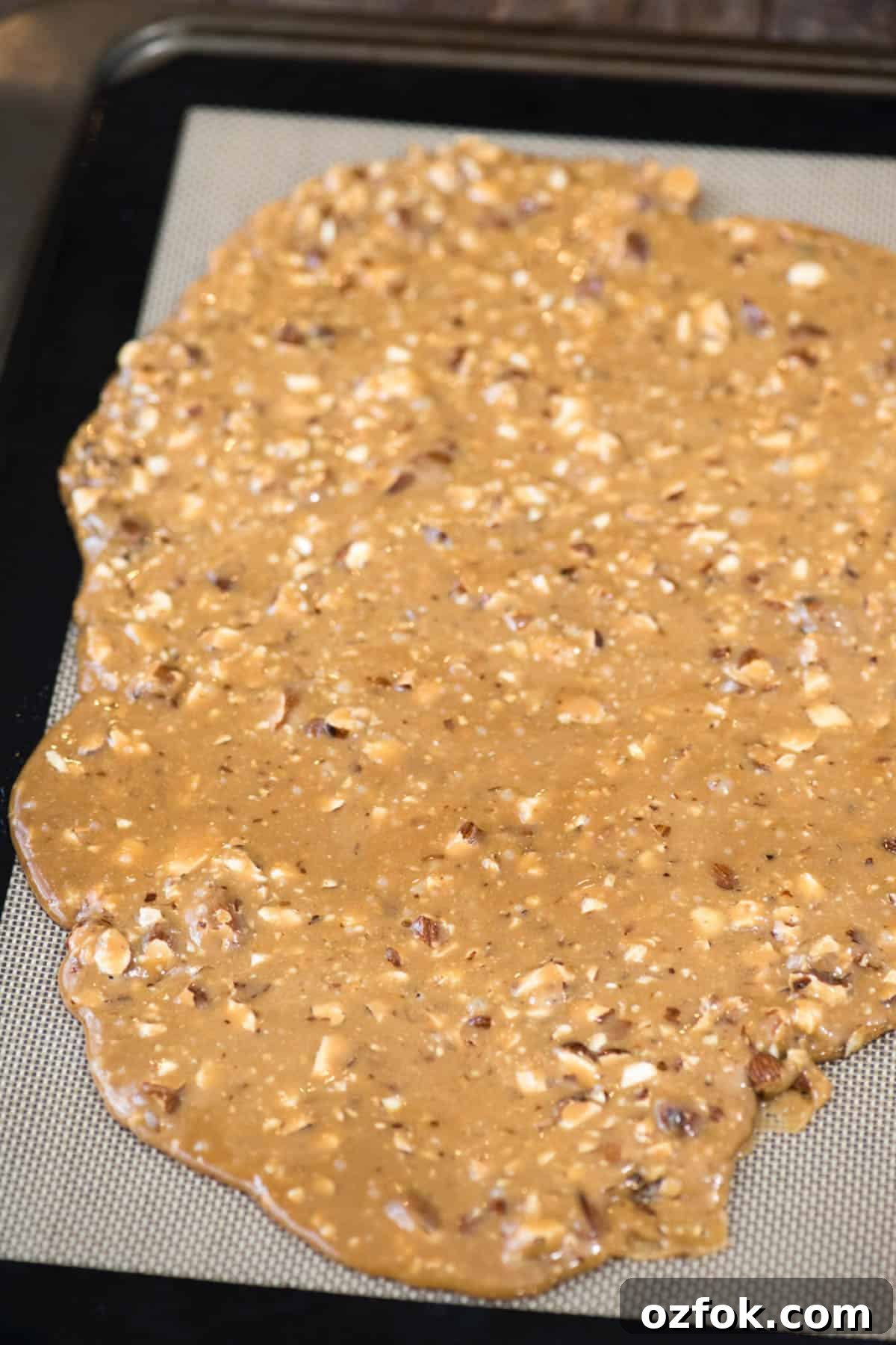 Traditional English Toffee Recipe: Crunchy Homemade Toffee in 4 Steps 2 toffee spread out over silicone baking mat