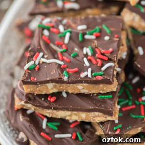 Traditional English Toffee Recipe: Crunchy Homemade Toffee in 4 Steps 5 Close-up of stacked toffee squares topped with a layer of chocolate and decorated with red, white, and green sprinkles, giving a festive holiday appearance.