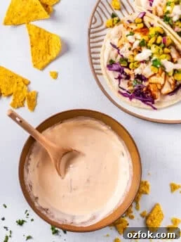 bowl of chipotle lime sauce and plate of fish tacos