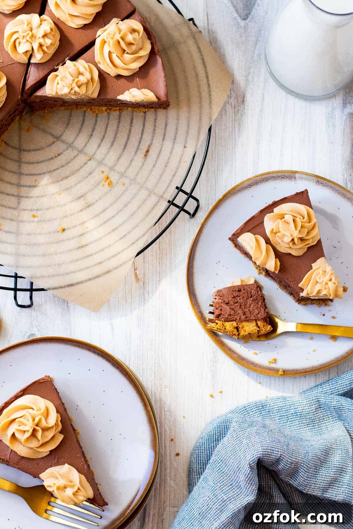 No-Bake Chocolate Peanut Butter Cheesecake Recipe 4 2 white plates with slices of cheesecake and the full cheesecake sitting on a wire rack