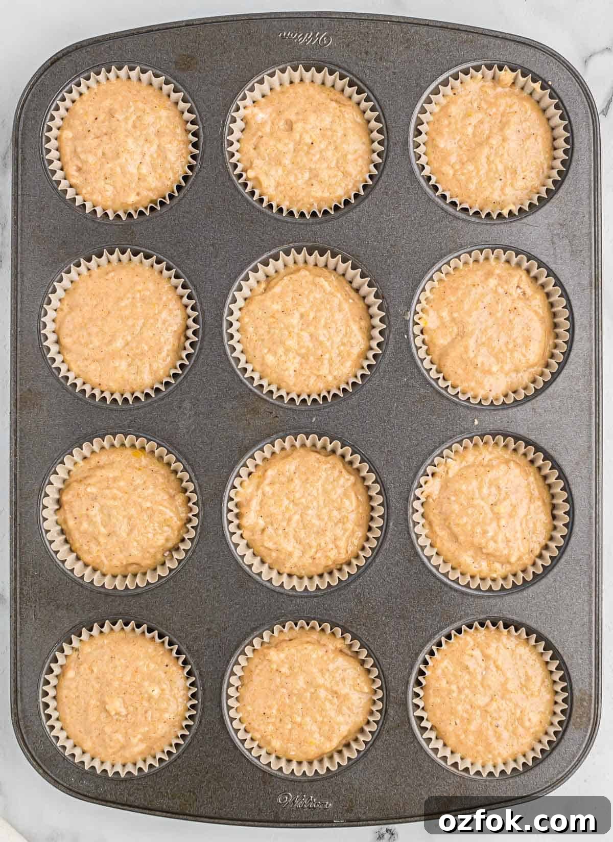 Moist Applesauce Muffins with Warm Cinnamon Sugar Topping 9 applesauce muffin batter in the muffin tin