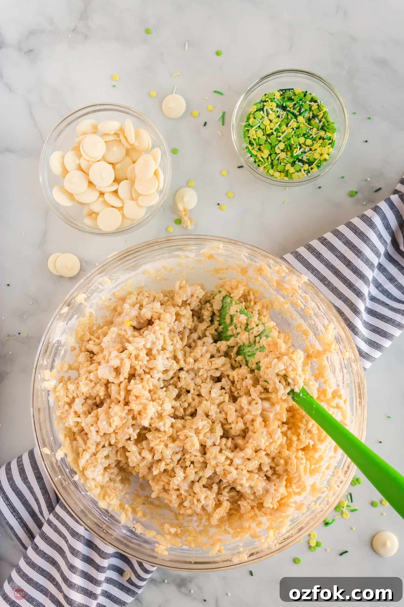 rice krispie treats being mixed in a bowl