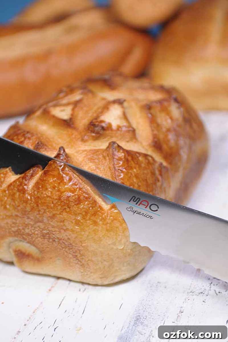 Top Bread Baking Tools Trusted by Foodal 10 Vertical image of a serrated knife slicing a loaf.