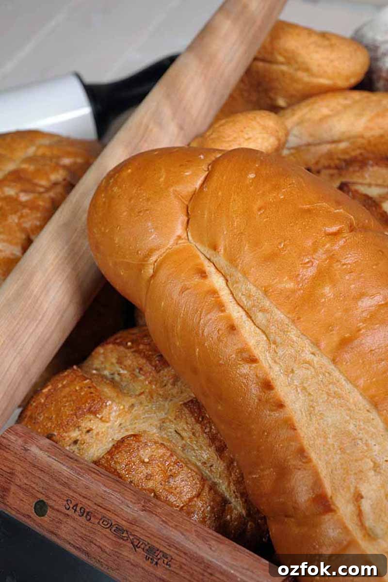 Top Bread Baking Tools Trusted by Foodal 3 Vertical close-up image of assorted baked goods next to a rolling pin.