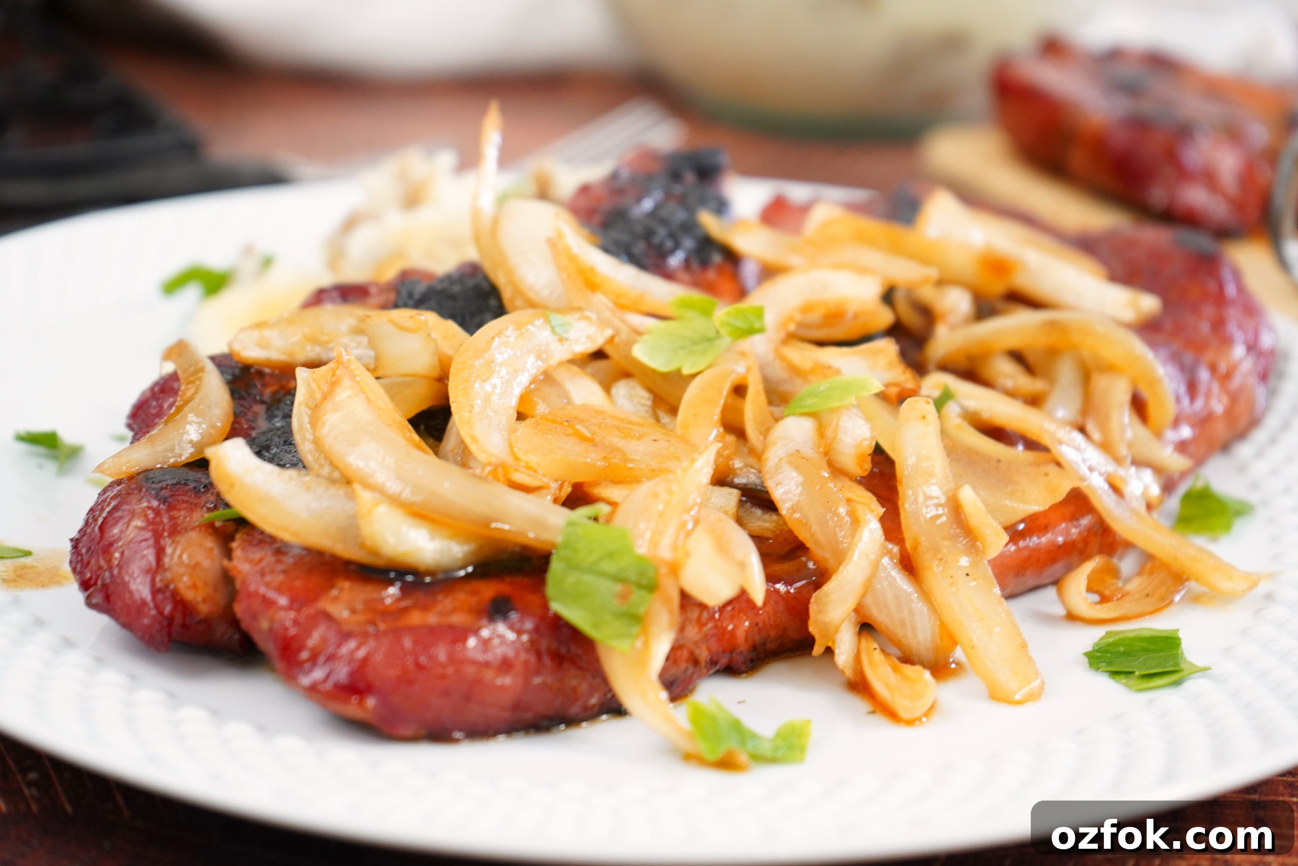 Smoked Pork Steaks with onions on plate. 