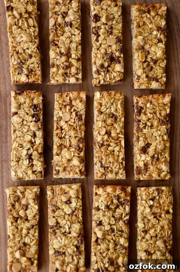 Homemade Peanut Butter Granola Bars Recipe – Chewy No-Bake Snack 3 Three rows of Homemade Peanut Butter Granola Bars on wood background