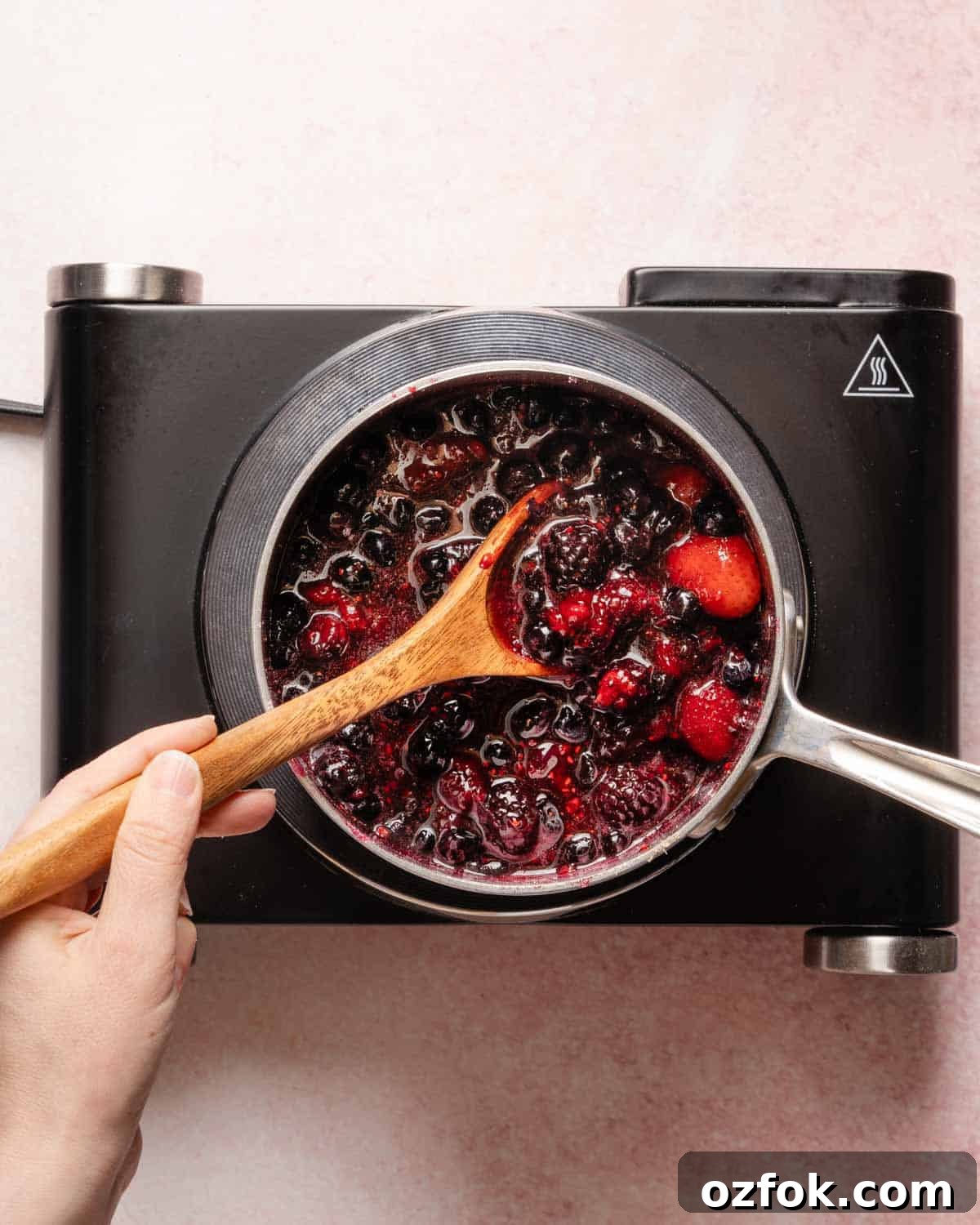 Refreshing Berry Lemonade Recipe: Bright Summer Drink Guide 5 berries and sugar being cooked in small pot on a burner.