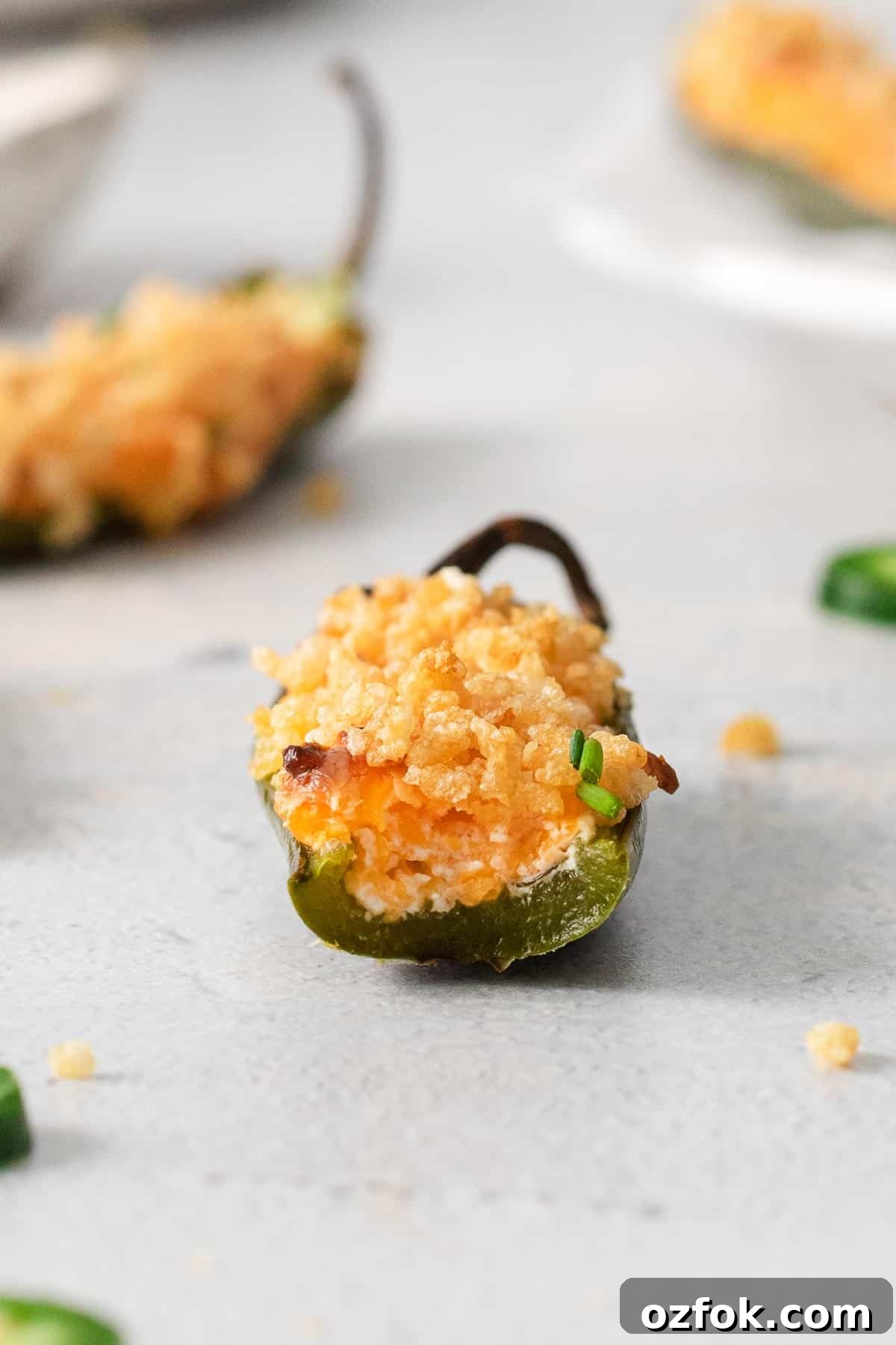 Gluten-Free Jalapeño Poppers Recipe: Crispy Stuffed Peppers 8 A jalapeno popper with a bite taken out of it