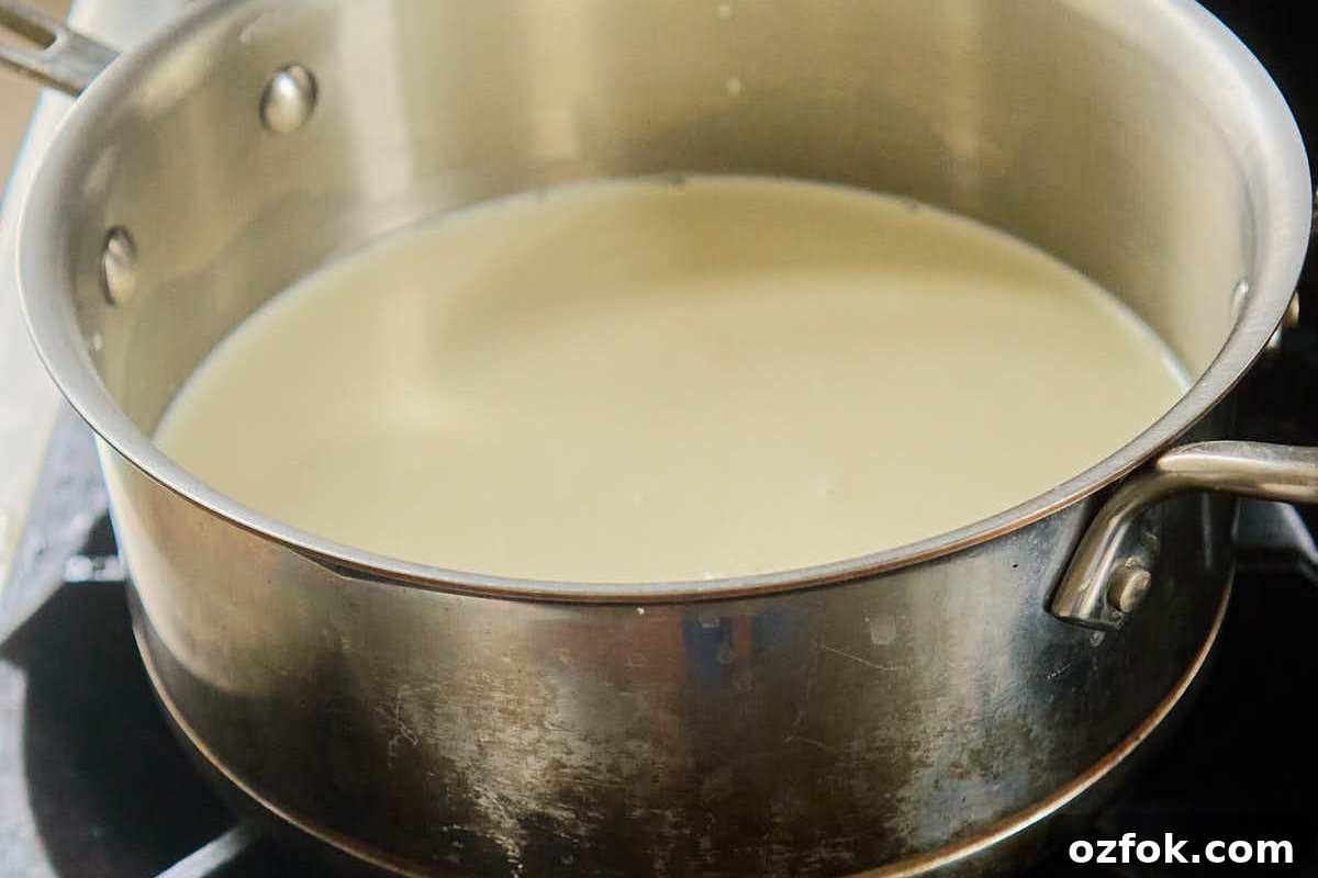 Classic Homemade Vanilla Ice Cream Recipe 4 milk mixture heating in saucepan.