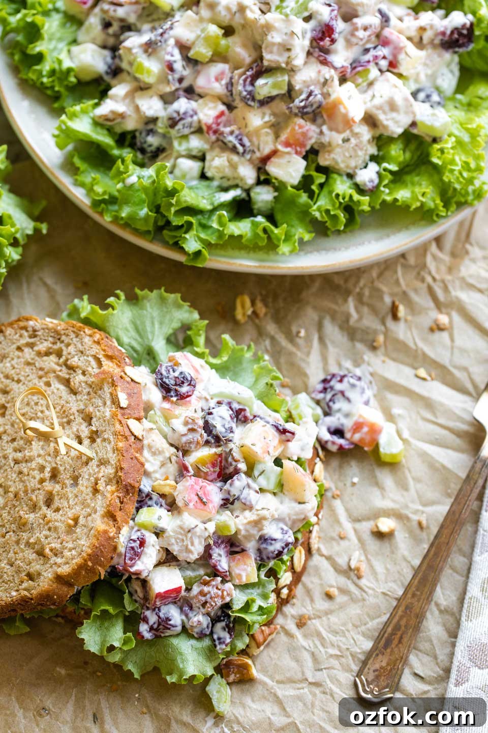 Overhead photo of two options of this turkey salad recipe served as a sandwich, and also plated as a salad on top of green, leafy lettuce.