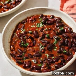 overhead view of saucy cooked kidney beans in a bowl.