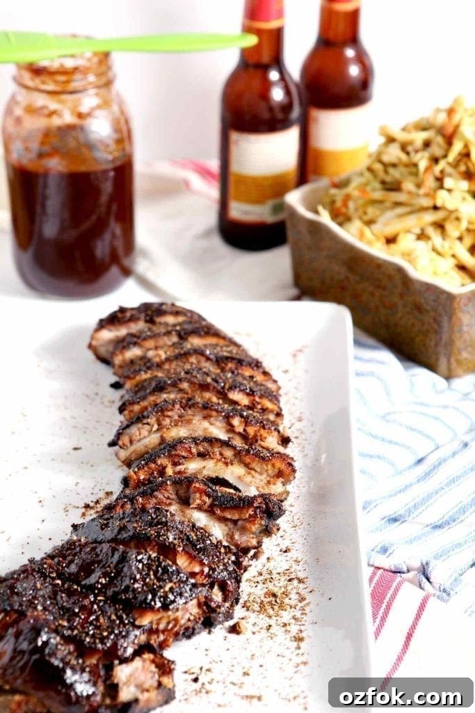 20+ Fourth of July Grilling Recipes for Your Backyard BBQ 13 A platter of Memphis-Style Barbecue Ribs sits with barbecue sides on red, white and blue linen.