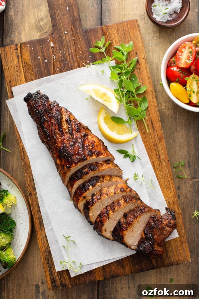 A whole grilled pork tenderloin sliced into medallions