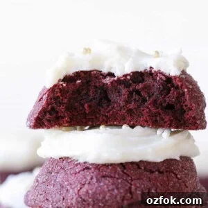 The inside of a red velvet cookie stacked on top of another red velvet cookie.