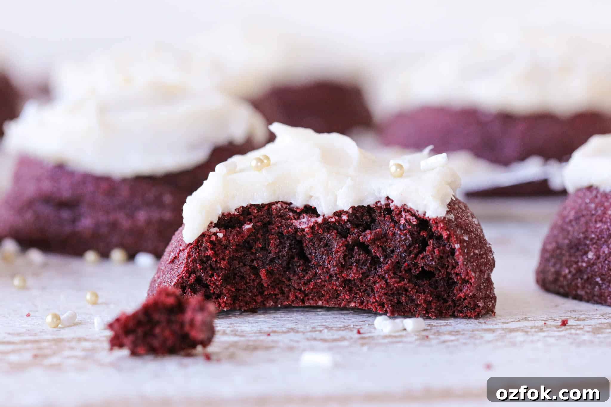 Decadent Red Velvet Cookies Recipe (Soft & Chewy) 5 A red velvet cookie's interior crumb complete with white frosting on top.