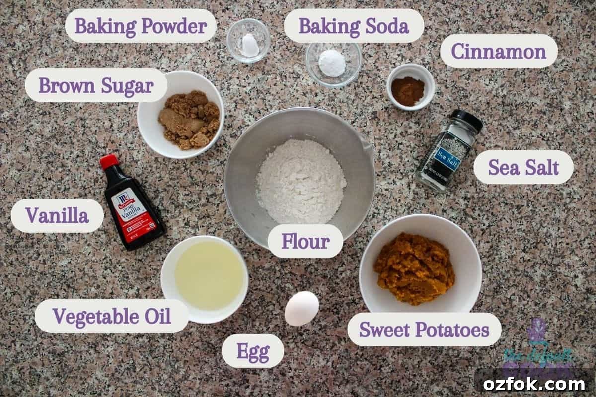 Labeled ingredients on a kitchen counter: vanilla, brown sugar, baking powder, baking soda, cinnamon, salt, flour, vegetable oil, egg, and mashed sweet potatoes.