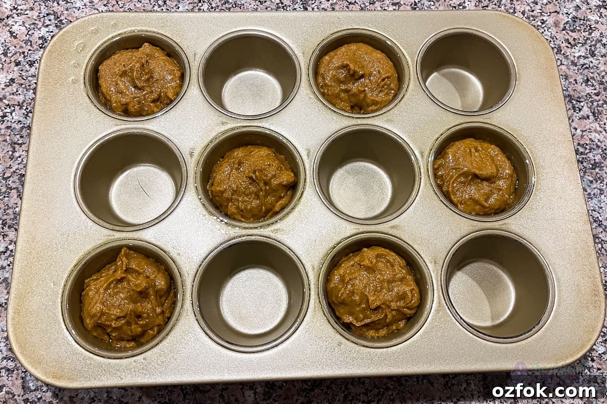Muffin tin with 6 of the 12 muffin wells filled, with every other well filled and every other well open.