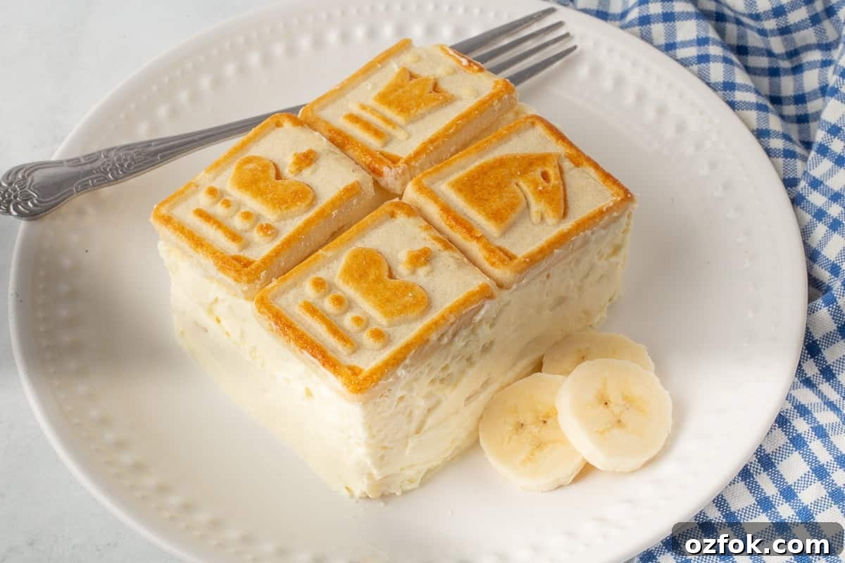 Paula Deen’s Banana Pudding Recipe — Classic Southern Twist 4 Serving of banana pudding on a white plate with a fork.