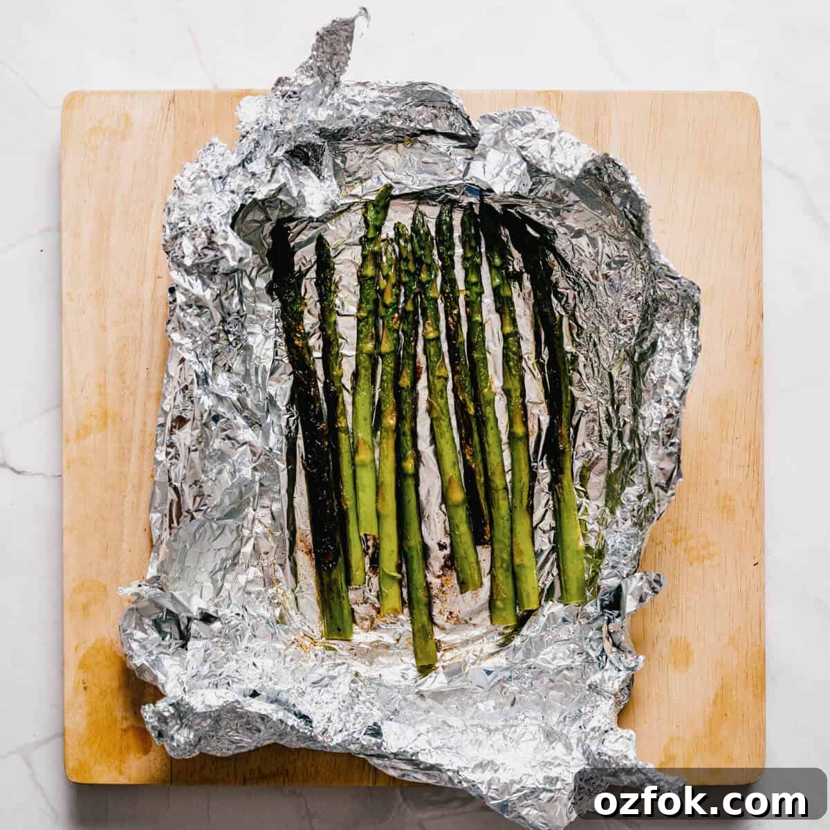 Foil-Grilled Asparagus with Lemon and Garlic 10 grilled asparagus spears in aluminum foil.