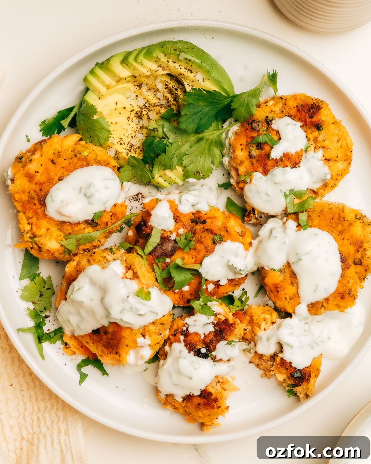 Moist Salmon Recipes That Stay Tender Every Time — Pro Tips Included 12 Salmon patties topped with dill sauce.