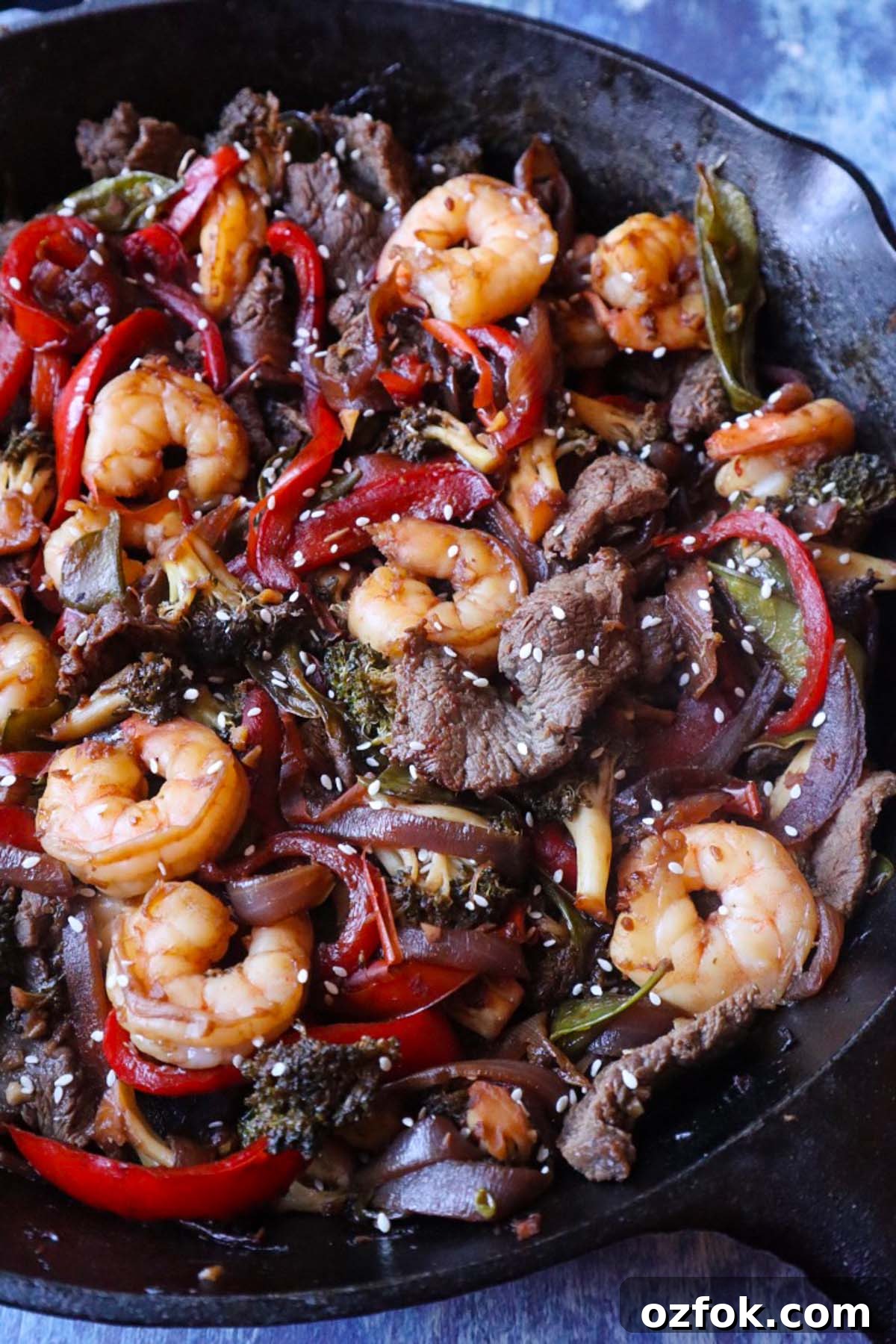 Shrimp and Steak Stir-Fry Recipe for Fast Weeknight Meals 6 cast iron skillet with stir fry shrimp, steak, and vegetables