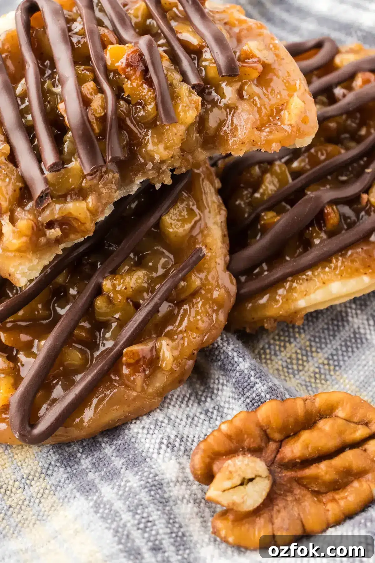 Pecan Pie Cookie Recipe: Chewy Cookies with Cinnamon Glaze 12 A pile of pecan pie cookies with a bite taken from one.