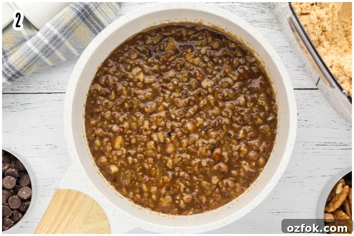 Pecan Pie Cookie Recipe: Chewy Cookies with Cinnamon Glaze 8 A white saucepan with pecan pie filling.