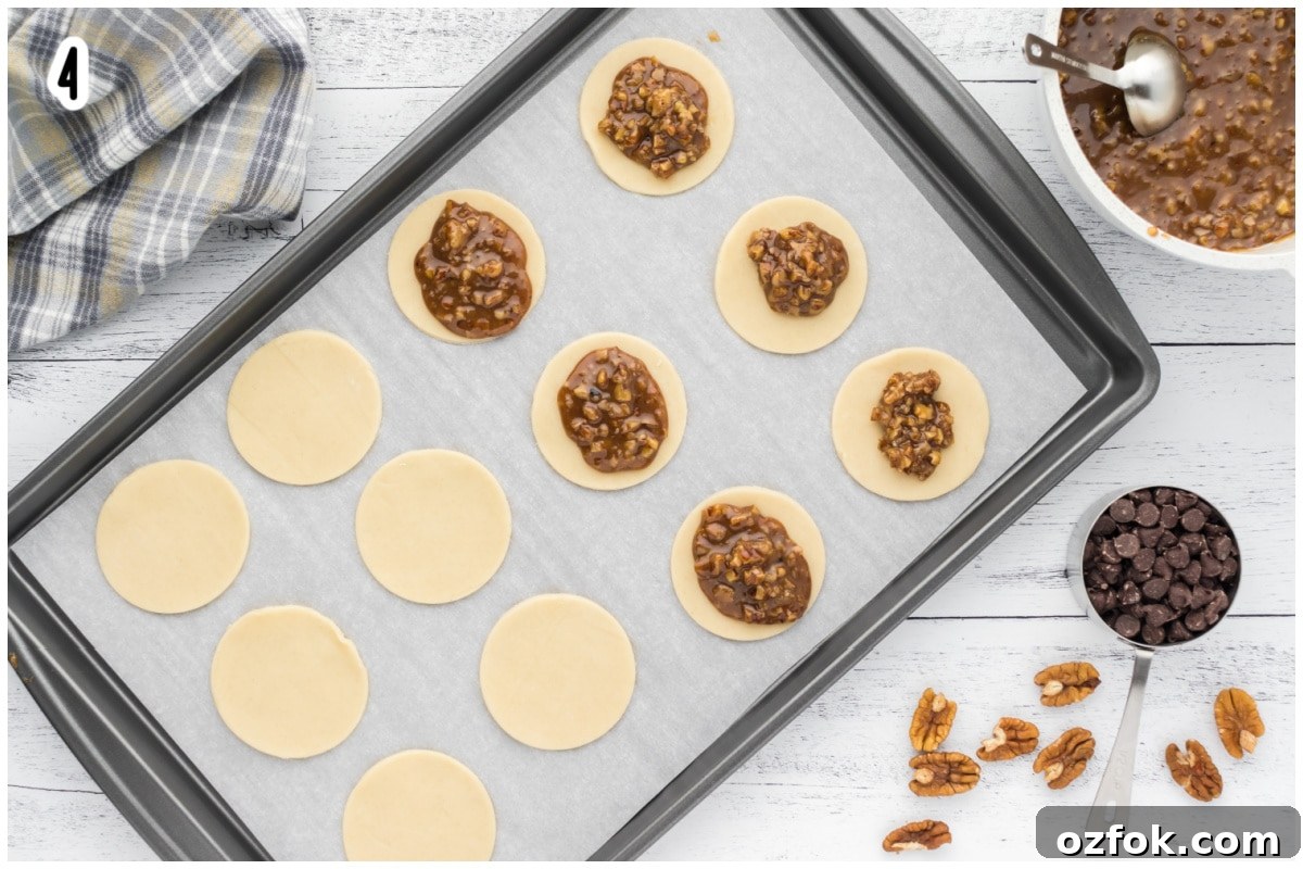 Pecan Pie Cookie Recipe: Chewy Cookies with Cinnamon Glaze 10 pie cricles on a cookie sheet lined with parchment paper.