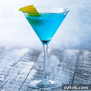 Angelo Azzurro cocktail in martini glass on grey table.