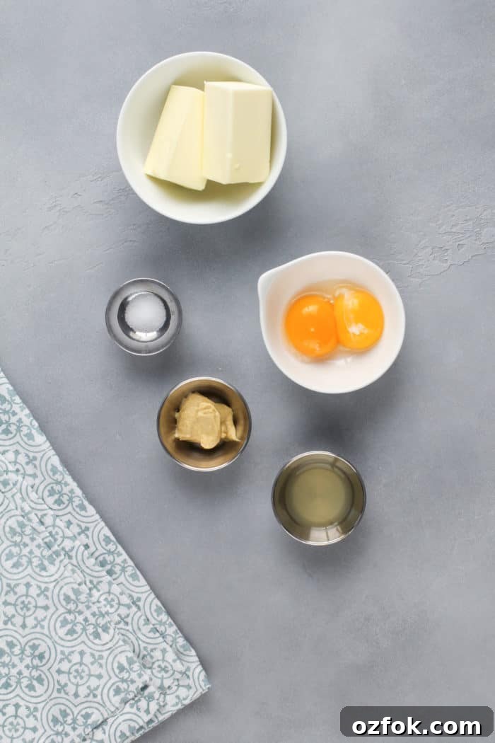 Classic Eggs Benedict Recipe: How to Make Perfect Hollandaise and Poached Eggs 4 Ingredients for hollandaise sauce on a gray countertop.