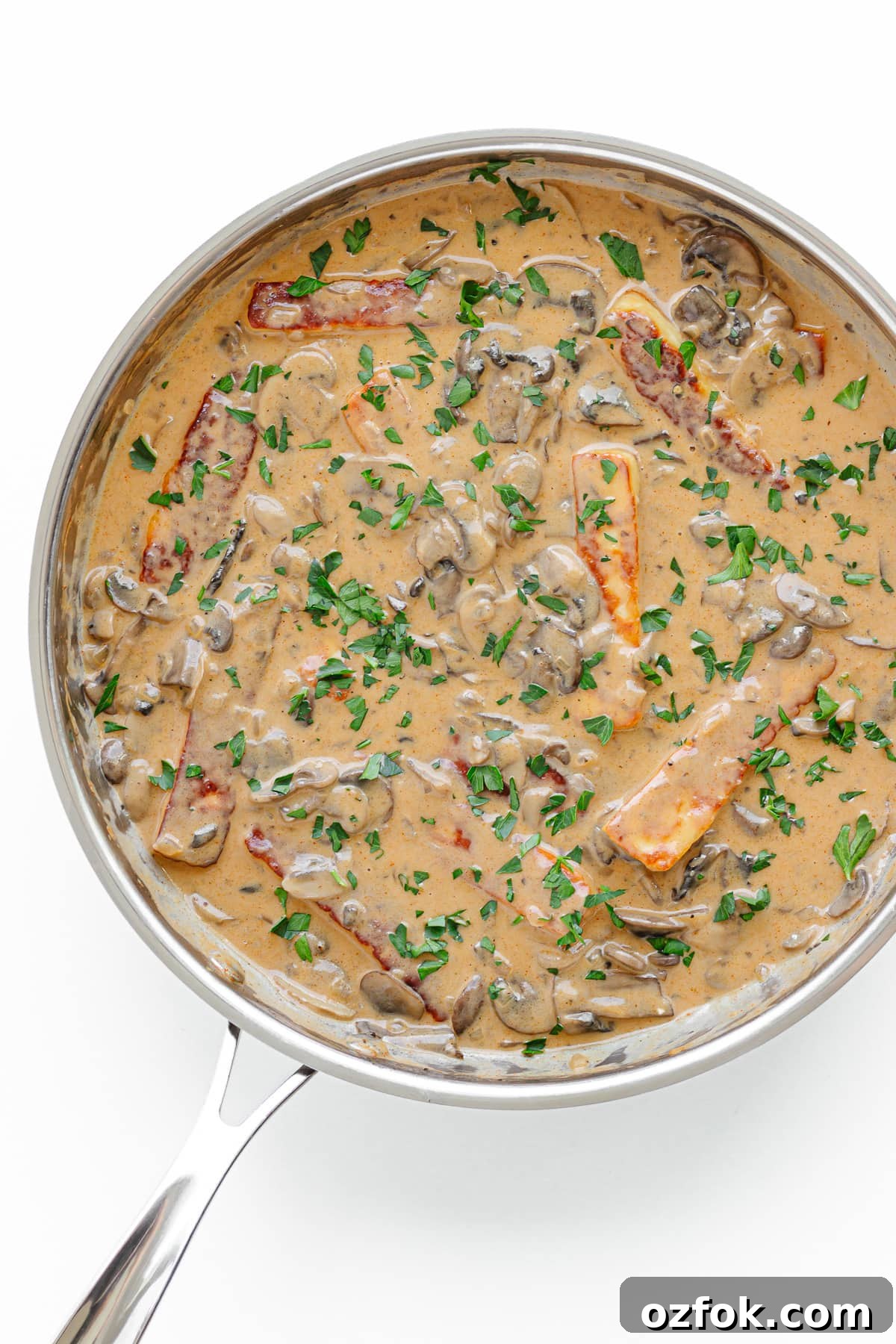 Creamy Halloumi Stroganoff with Mushrooms and Thyme 3 Halloumi Stroganoff in a stainless steel skillet on a white background.