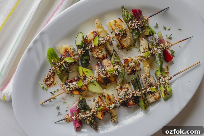 Spread Za'atar seasoning over luscious grilled skewers of Halloumi Cheese, Fresh Spring Asparagus and Scallions