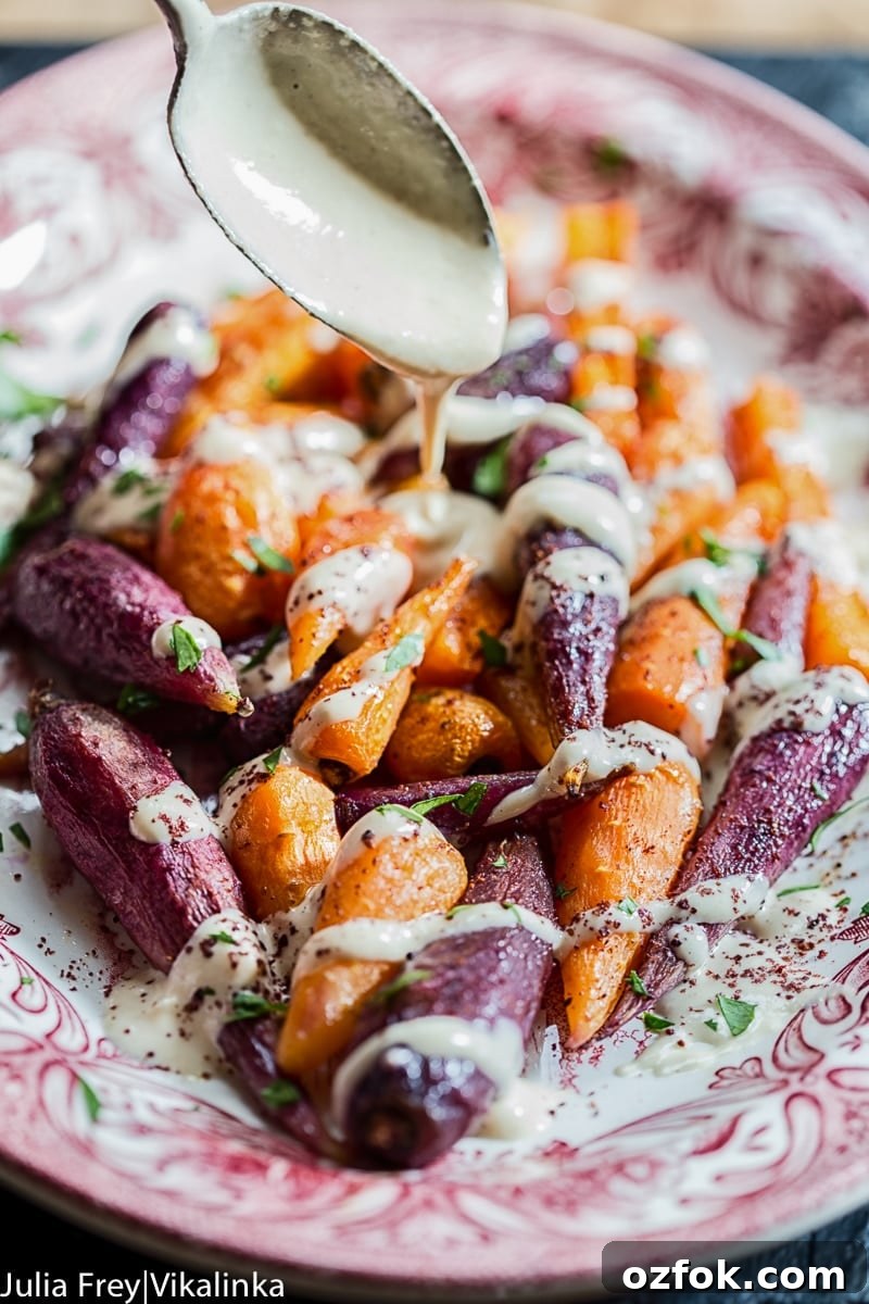 Roasted Carrots with Lemon Tahini and Garlic Sauce 3 spoon pouring tahini sauce over roasted carrots
