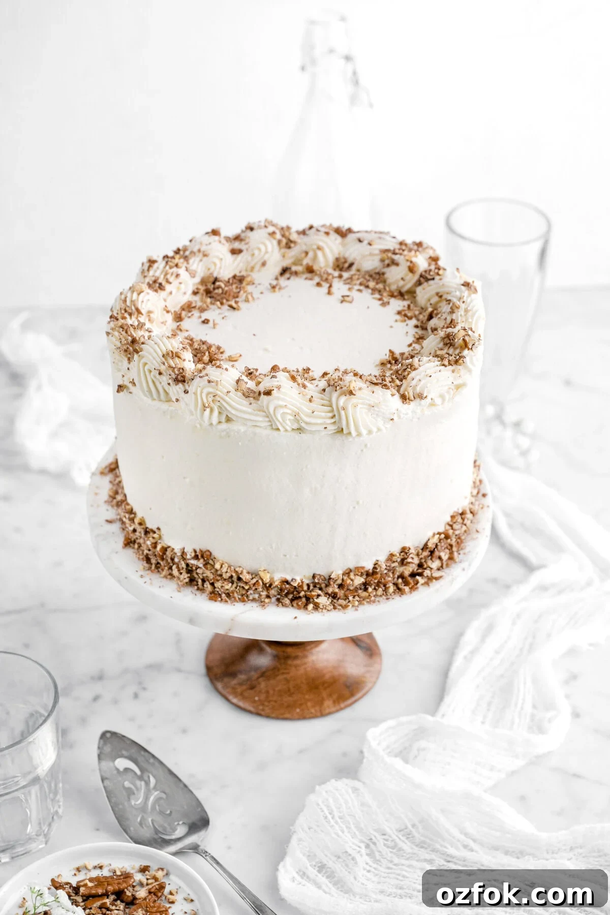 hummingbird cake with chopped pecans on top.