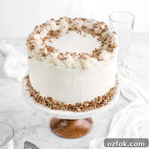 hummingbird cake with chopped pecans on top.