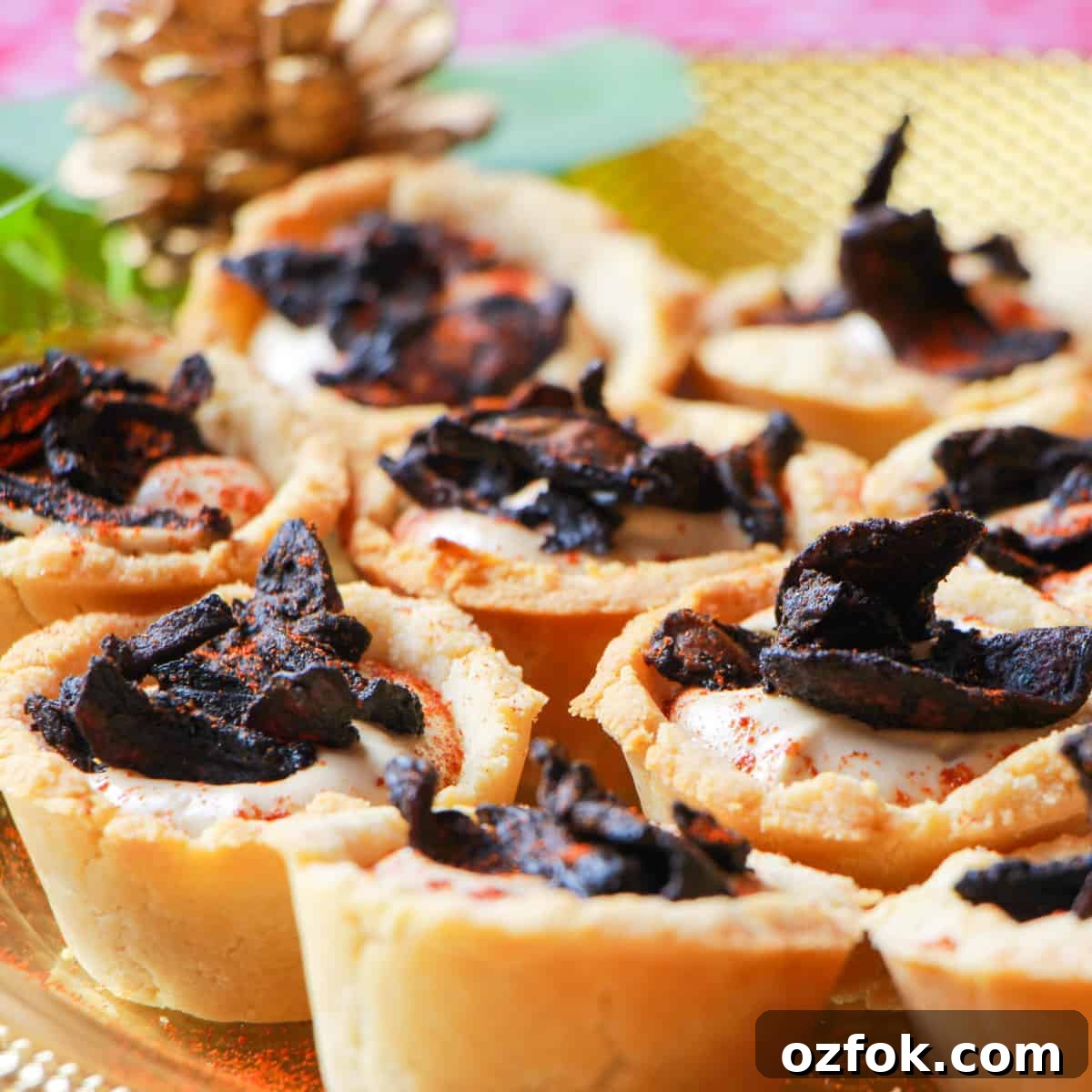 Close-up photo of a plate of mushroom bacon and black garlic cashew cream tartlets