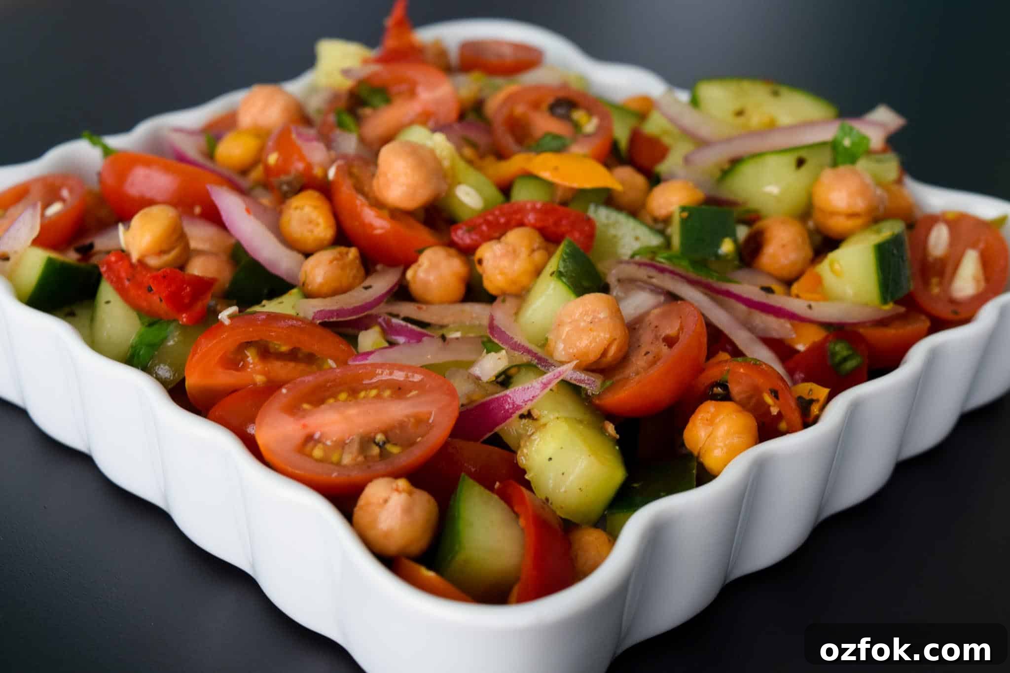 Roasted Chickpea Panzanella Salad in white serving tray close up view