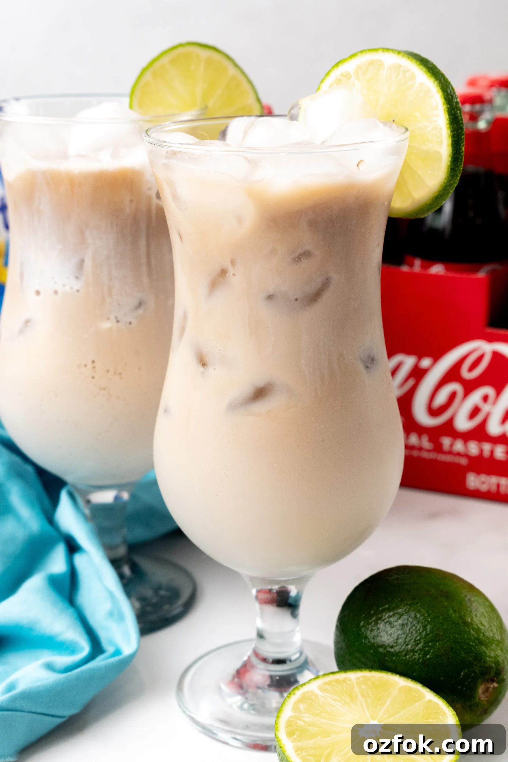 How to Make Viral Dirty Soda at Home: TikTok Recipe Guide 2 two dirty sodas over ice in daquiri style glasses with a slice of lime on the rim