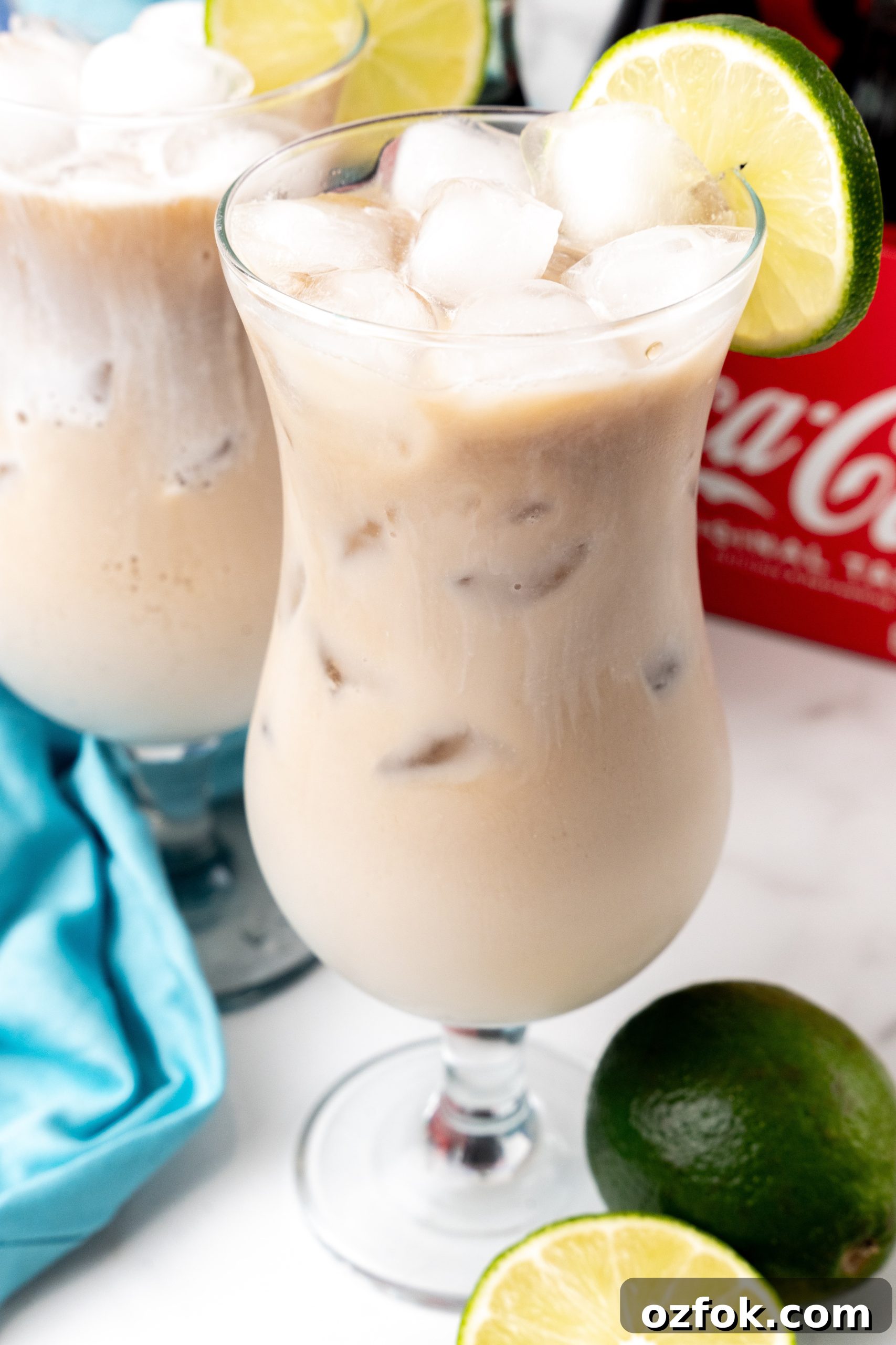 How to Make Viral Dirty Soda at Home: TikTok Recipe Guide 3 two dirty sodas over ice in daquiri style glasses with a slice of lime on the rim