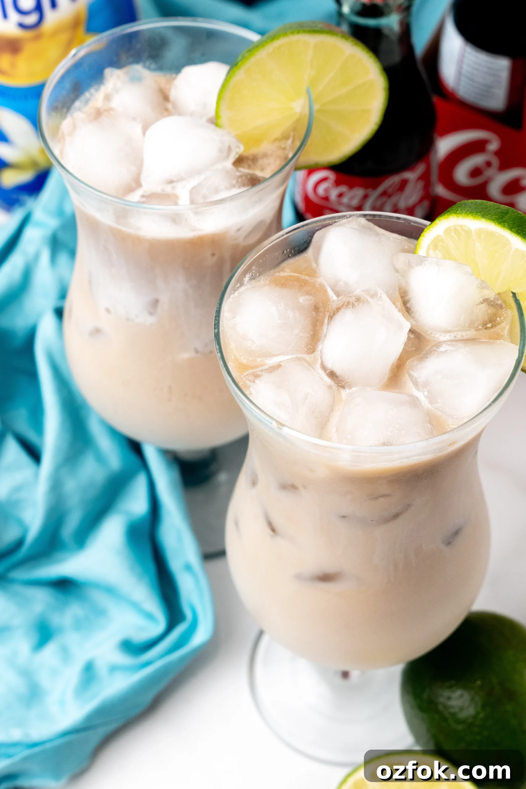 How to Make Viral Dirty Soda at Home: TikTok Recipe Guide 7 two dirty sodas over ice in daquiri style glasses with a slice of lime on the rim