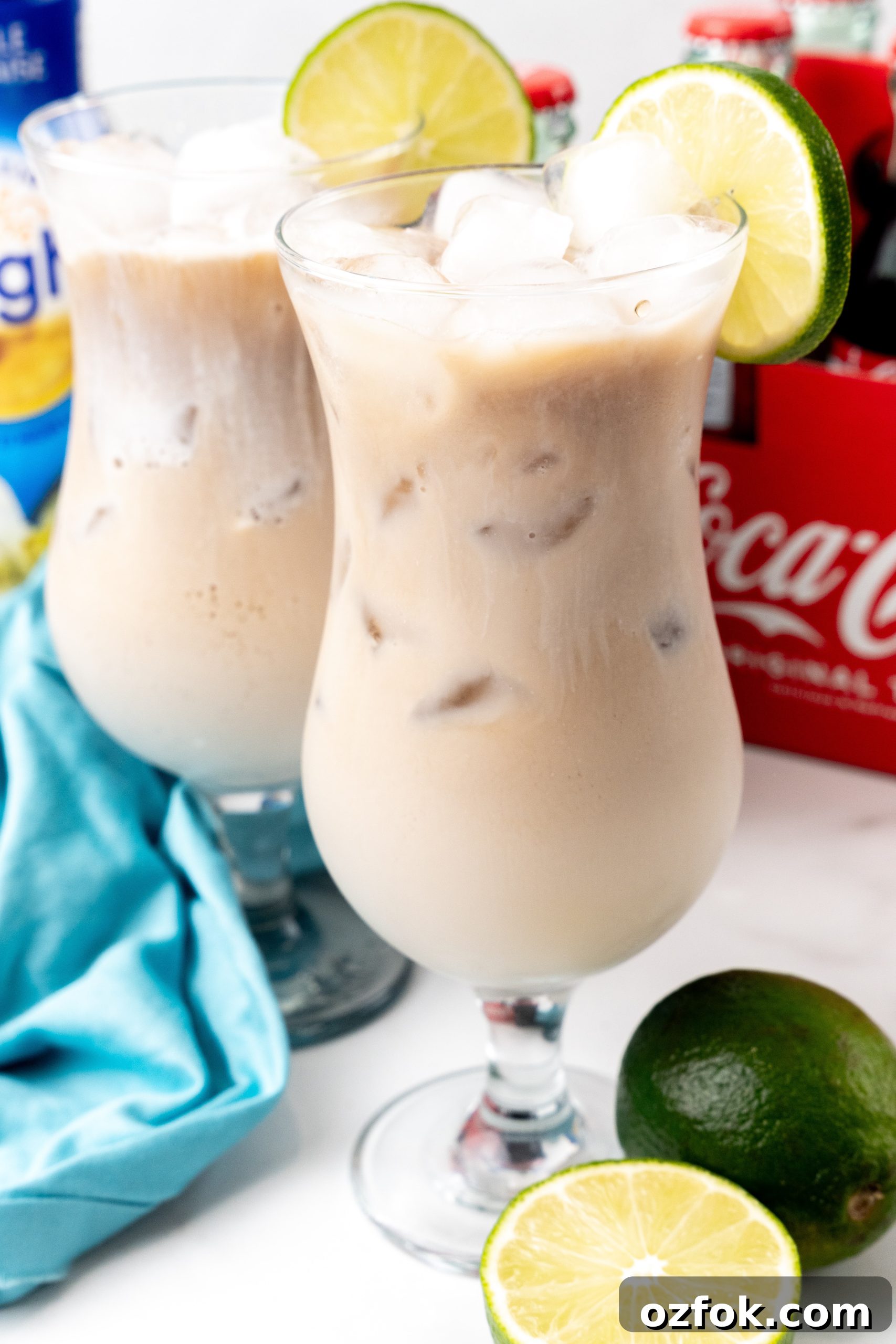 How to Make Viral Dirty Soda at Home: TikTok Recipe Guide 8 two dirty sodas over ice in daquiri style glasses with a slice of lime on the rim
