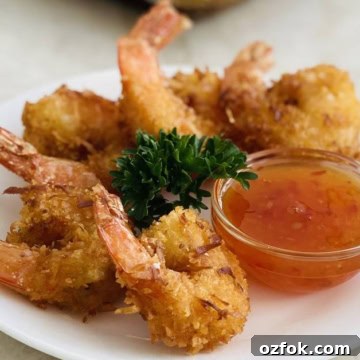 plate of crispy coconut shrimp with dipping sauce