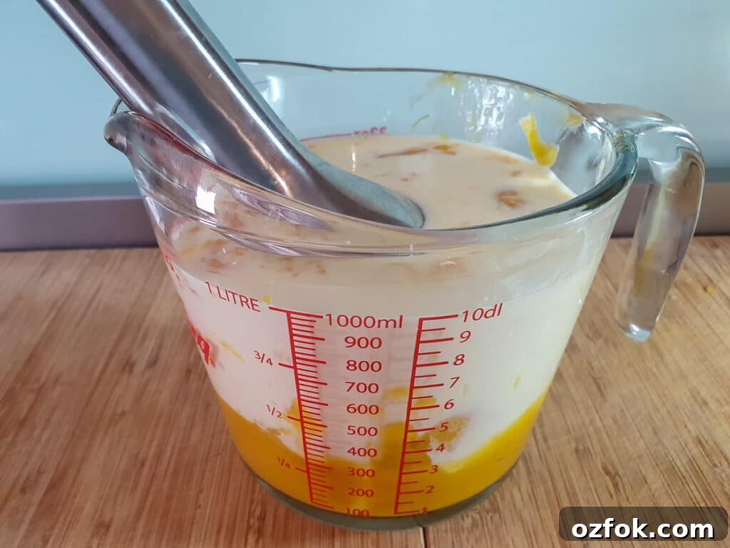 Creamy Mango Ice Cream Recipe: Fresh Mango Frozen Dessert 11 Blending mango puree and rest of ice cream mix together with a stick blender.