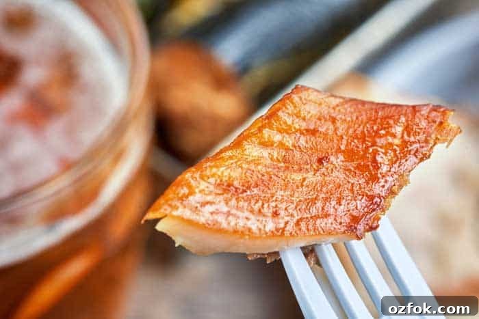 Top Fish to Smoke: 13 Varieties for Flavorful Results 12 beautiful orange colored mackerel piece on fork